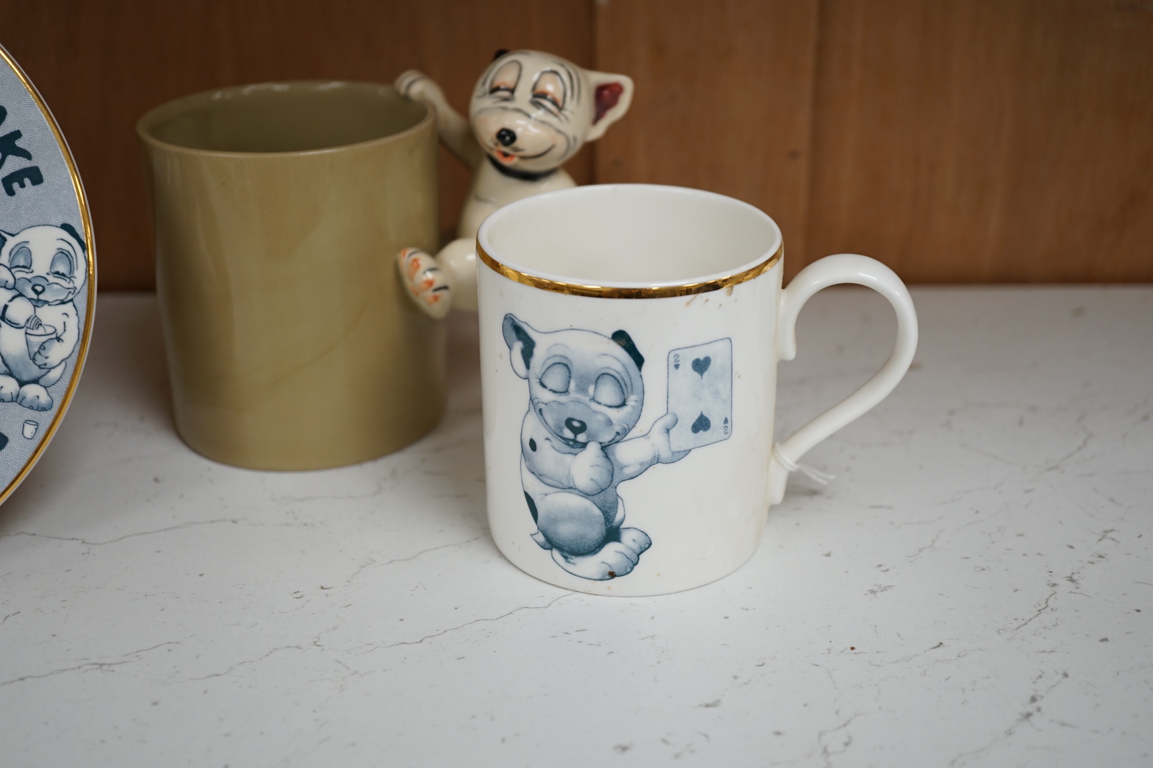A Richard Dennis Bonzo Dog mug and matching plate and a Dennis China glazed pottery mug, plate 17cm diameter (3). Condition - slight chip to base edge of plate